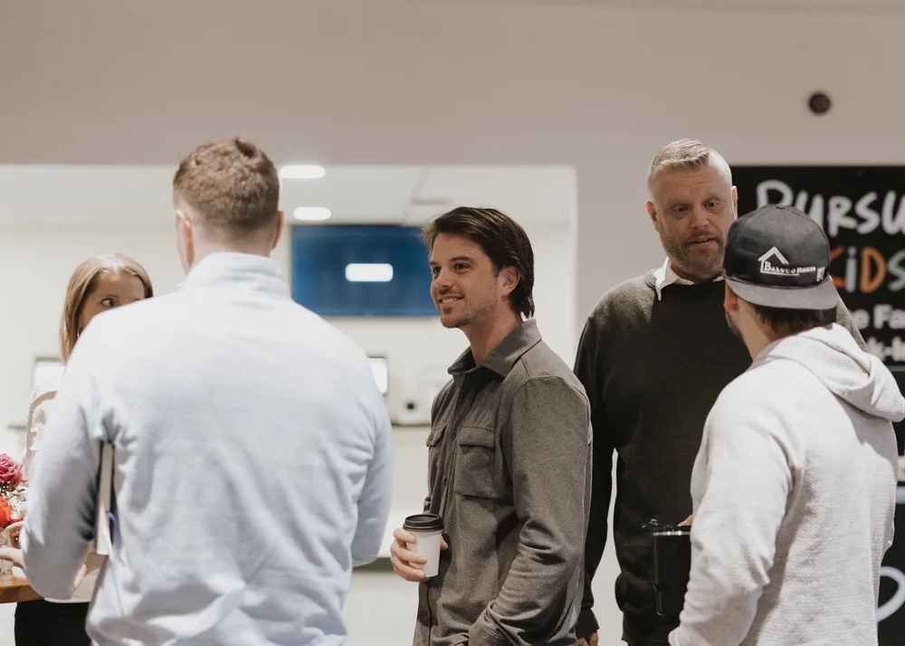 Pursuit Marketplace members talking over coffee